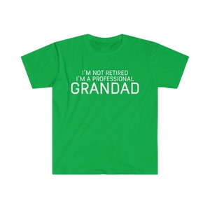 May include: Green t-shirt with white text that reads "I'm not retired I'm a professional Grandad."
