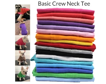 May include: A stack of 14 basic crew neck t-shirts in various colors, including red, pink, purple, light pink, orange, yellow, grey, black, white, turquoise, blue, green, and light blue. The text "Basic Crew Neck Tee" is at the top of the image.