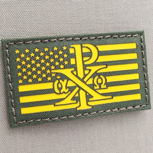 May include: A green and yellow embroidered patch with an American flag design and the letters "IXO" in the center.