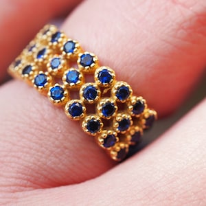 Estate vintage solid 18K gold wide band set with many synthetic blue stones