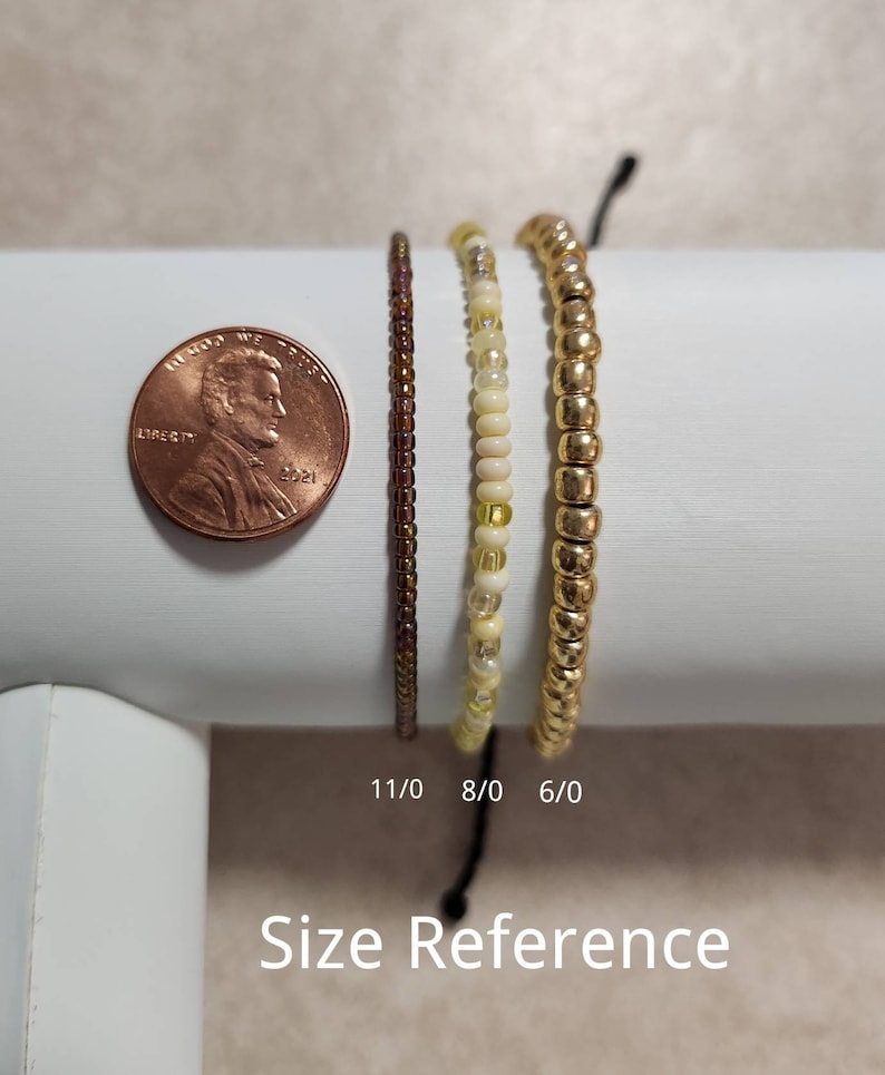 May include: Three beaded bracelets in different sizes, shown next to a US penny for size reference. The bracelets are 6/0, 8/0, and 11/0 sizes.