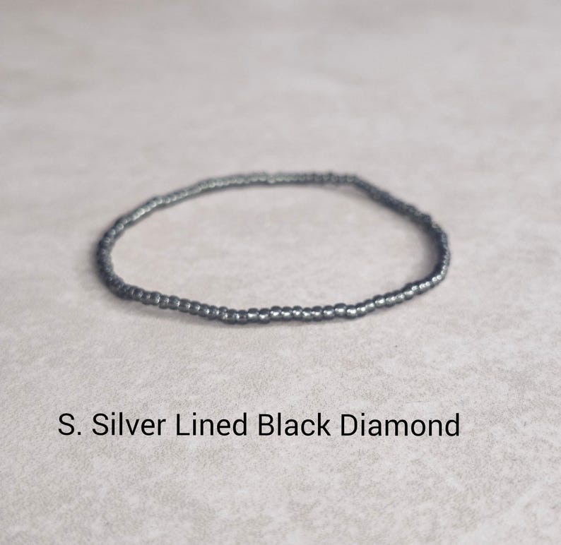 May include: A silver lined black diamond beaded bracelet.