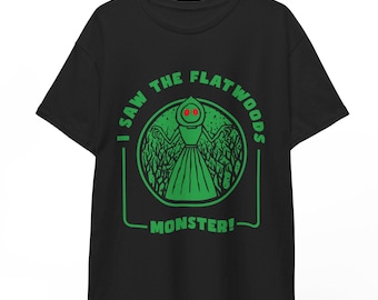 May include: Black t-shirt with a green circle graphic that says "I saw the Flatwoods Monster!" The graphic features a green creature with red eyes.