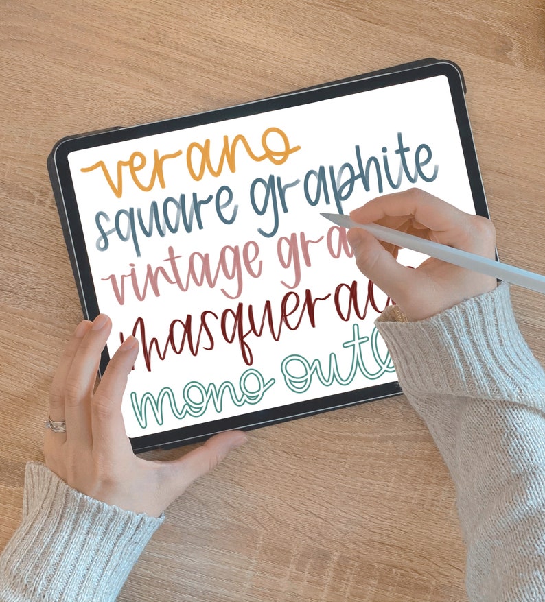 May include: A digital tablet with a white screen displaying handwritten text in various colors. The text includes "verano", "square graphite", "vintage gra", "masquerad", and "mono out".