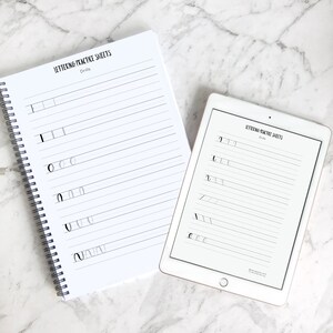 May include: Two white practice sheets for lettering drills. The sheets have lines for practicing different letter strokes. The top sheet is in a bound notebook and the bottom sheet is on a tablet.