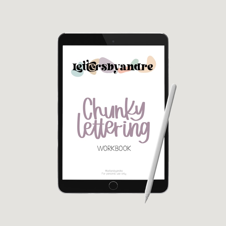 May include: A digital tablet displaying a workbook titled "Chunky lettering WORKBOOK" with the text "lettersbyandre" at the top. The tablet is on a grey background with a white stylus next to it.