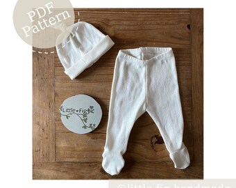 May include: A white baby hat and a pair of white baby leggings with a small pattern. The hat has a knot on top. The leggings have a fold-over cuff at the ankles. The items are laid out on a wooden surface. The text "PDF Pattern" is in a circle above the hat. The text "Little Fig" is in a circle below the hat. The text "@little.fig.handmade" is at the bottom of the image.