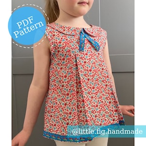 May include: PDF pattern for a sleeveless dress with a Peter Pan collar and a floral print. The dress has a blue ribbon tied at the neck and a blue trim around the bottom.