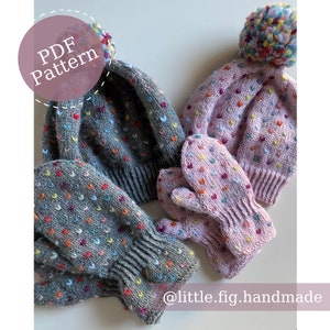 May include: Two sets of knitted hats and mittens. One set is gray with colorful hearts and the other is pink with colorful hearts. The hats have pom-poms on top. The image includes the text "PDF Pattern" and "@little.fig.handmade".