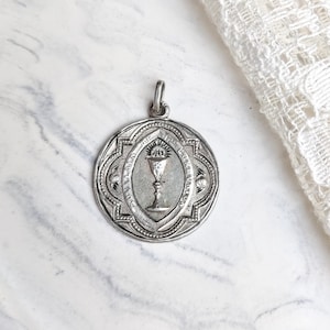 Antique silver communion pendant