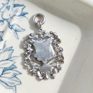 Vintage silver pendant/watch fob, with clean cartouche (1938)