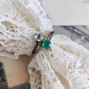 Toi et Moi silver ring with clear and green glass stones