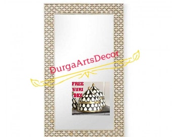May include: A large rectangular mirror with a decorative bone inlay frame. The frame is made of small, geometric shapes in a light beige colour with a darker beige border. The mirror is reflecting a small image of three black and white decorative boxes with gold accents. The text "FREE SURIBOX" is visible in the reflection.
