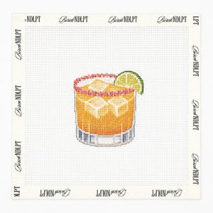 May include: A needlepoint canvas featuring a cross-stitched cocktail in a glass with ice cubes, a lime wedge garnish, and a red rim. The white canvas border is printed with the repeating text Birch NDLPT in a black serif font on all four sides.