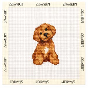 May include: A needlepoint canvas featuring a cross-stitched golden-brown puppy with a white chest patch, centered on a white grid background. The border of the canvas is printed repeatedly with the text BirchNDLPT in a black serif font.