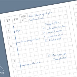 May include: A detailed planner page with a grid layout, featuring handwritten notes in blue ink. The page is dated December 17, 2021, and includes a schedule with entries like "yoga," "work on project plan," and "meeting with Jen." The planner also has a logo of a moth.