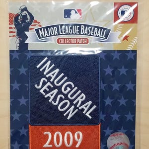 May include: A Major League Baseball collector patch in a clear plastic sleeve. The patch features the text "INAUGURAL SEASON 2009" on a navy blue and orange background. The packaging includes the MLB logo and a baseball.