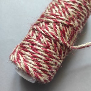 May include: A roll of red and natural twine, perfect for crafting and gift wrapping.