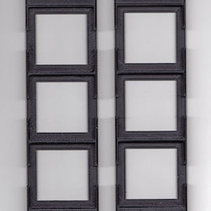 May include: Two black plastic slide mounts with three rectangular openings for 127 slide film. Each mount has the text "127 SLIDE" printed on the bottom.