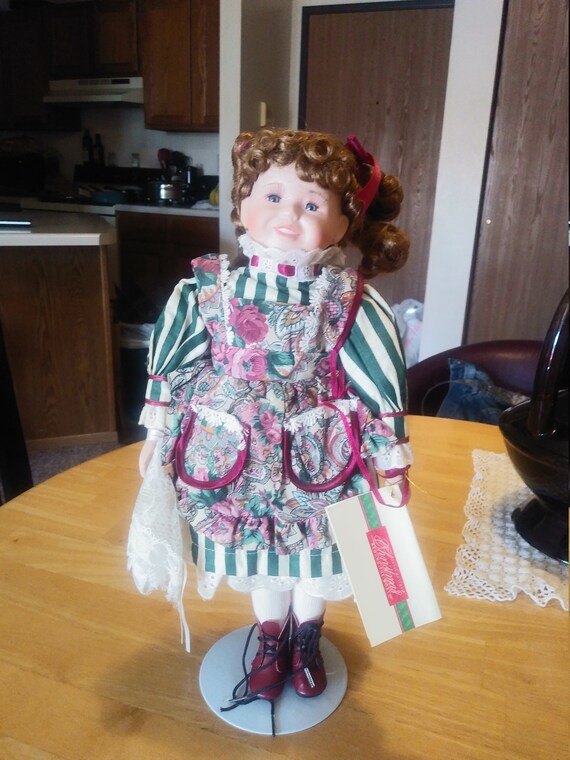 Porcelain Doll #204 Christmas around the world Mary Ann doll. Circa. 1980s with stand.