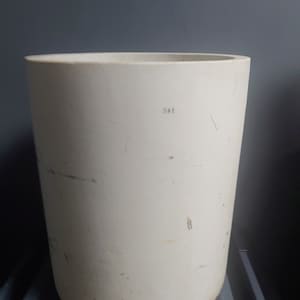 May include: White ceramic cylinder with the word "DAY" written on the side.