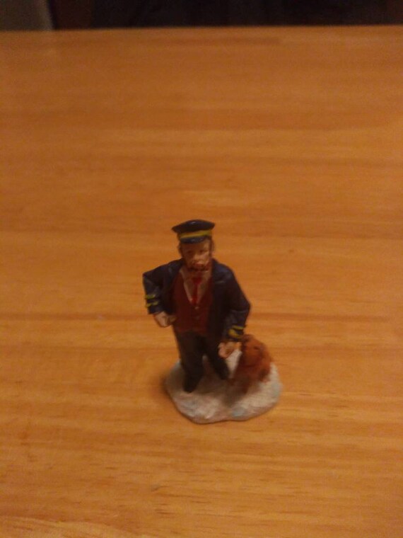 Miniature train engineer with dog Figurine Circa. 1980s