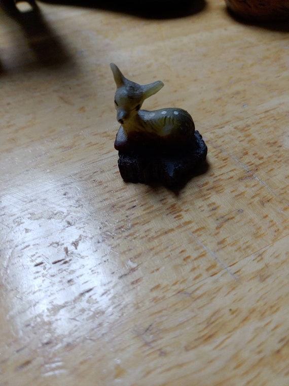 Miniature fawn on a log Circa. 1970s