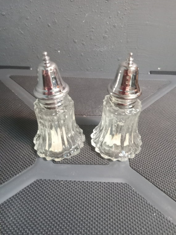 A pair of silver-plated salt and pepper shakers