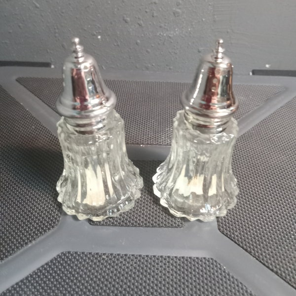 A pair of silver-plated salt and pepper shakers
