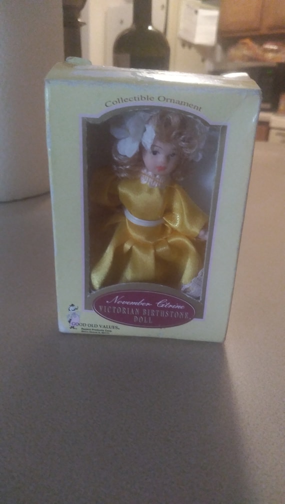Porcelain doll # 41 November citrine Victorian Birthstone doll in yellow dress with white lace in original box.