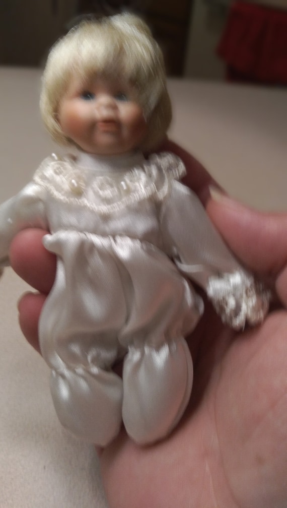 Porcelain doll # 20 white satin pajamas with pearls and white lace. Circa. 1980s