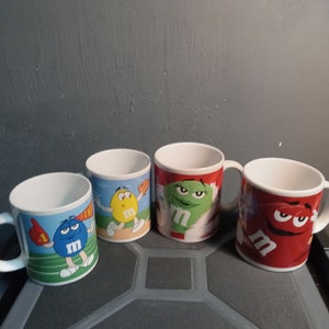 Set of 4 galerie M&M collector mugs Circa. 2003