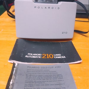 Polaroid 210 Automatic Land Camera with owners manual and cooling film plates. Circa. 1967