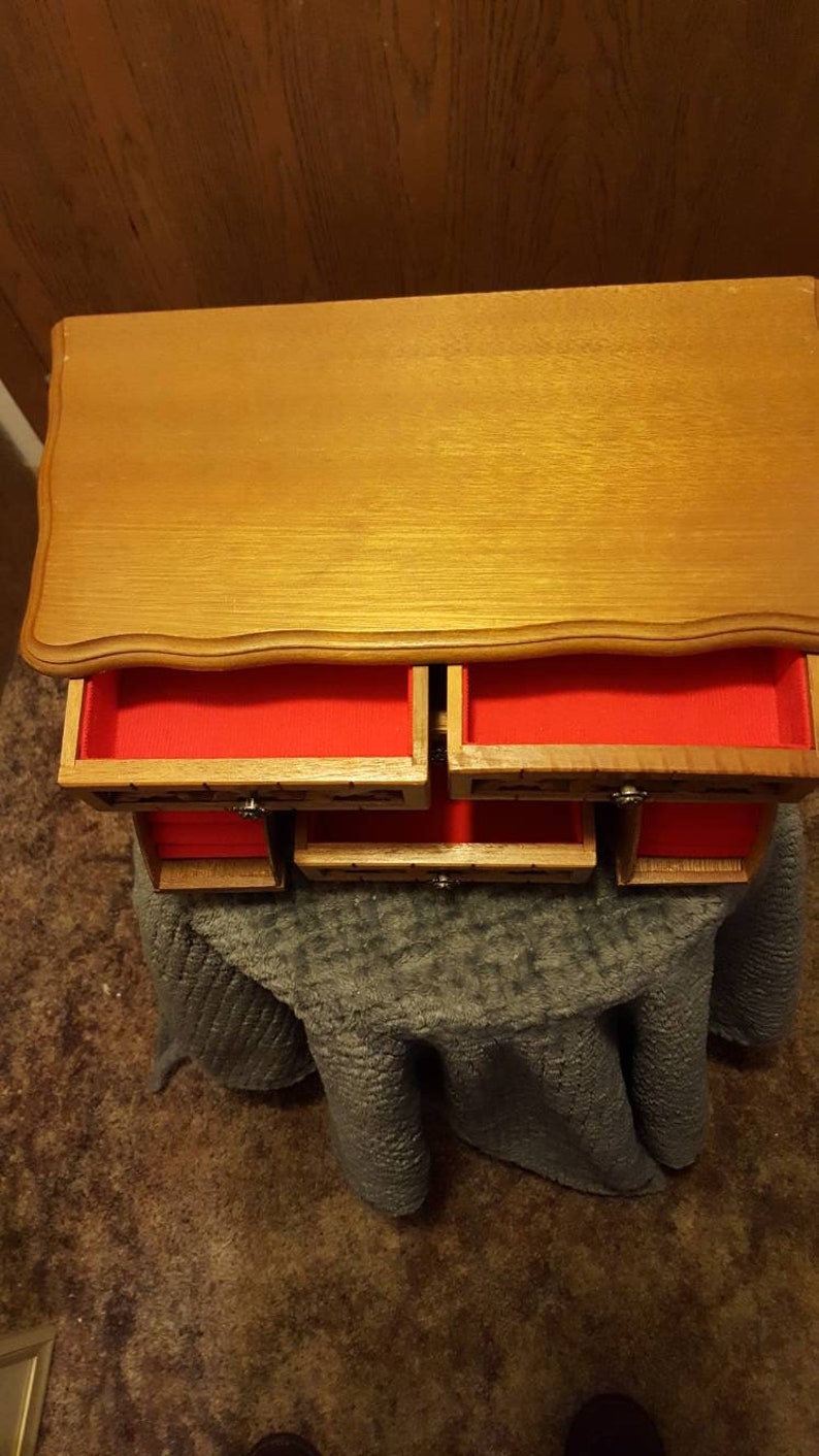 6 drawer wooden Jewelry Box with red felt inserts.