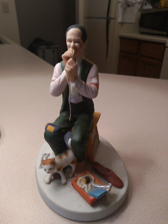 A man threading a needle by Norman Rockwell. Hand Crafted in September 1980 by the Danbury Mint.