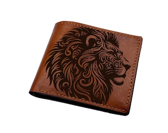 May include: A brown leather wallet with a detailed, black, engraved design of a lion's head.