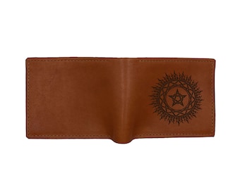 May include: A brown leather wallet with a star and sun design embossed on the front.