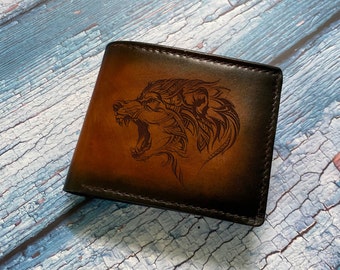 May include: A brown leather wallet with a detailed wolf design embossed on the front.