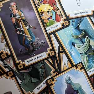 May include: A close-up of a stack of tarot cards featuring illustrations of swords, a woman with a sword, a tree, and an elf. The cards have a black and gold border with a decorative pattern.