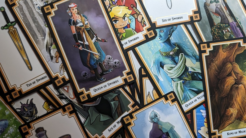 May include: A close-up of a stack of tarot cards featuring illustrations of swords, a woman with a sword, a tree, and an elf. The cards have a black and gold border with a decorative pattern.