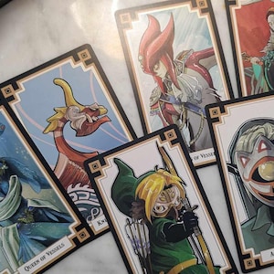 May include: A set of playing cards featuring illustrations of characters from the Legend of Zelda video game series. The cards are decorated with a gold and black border and feature a variety of characters, including Link, Zelda, and Ganondorf. The cards are in a variety of colors, including blue, green, red, and yellow.