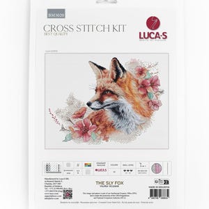 May include: A Luca-S cross stitch kit titled The Sly Fox, featuring a printed illustration of a fox surrounded by pink flowers. The packaging includes the product code BM3020, technical specifications, a barcode, and contact information.