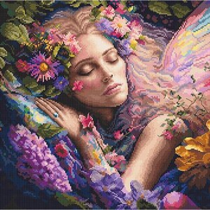 May include: A diamond painting kit featuring a pixelated illustration of a person with closed eyes resting among vibrant flowers. The scene includes purple lilacs, pink blossoms, and large yellow petals, with a soft, ethereal wing-like shape.