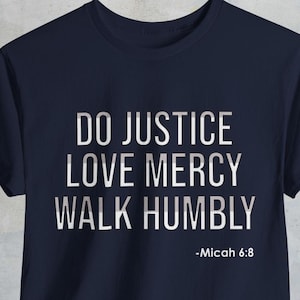 May include: Navy blue t-shirt with white text that reads "Do Justice Love Mercy Walk Humbly -Micah 6:8".