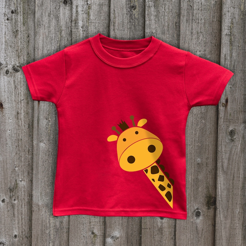 May include: Red short-sleeved t-shirt with a yellow giraffe head peeking out from the side.