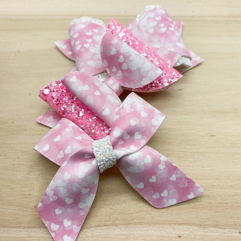 Adorable pink and white watercolour heart faux leather and chunky glitter bows pink and white heart Valentine\u2019s pigtail bows or headbands.