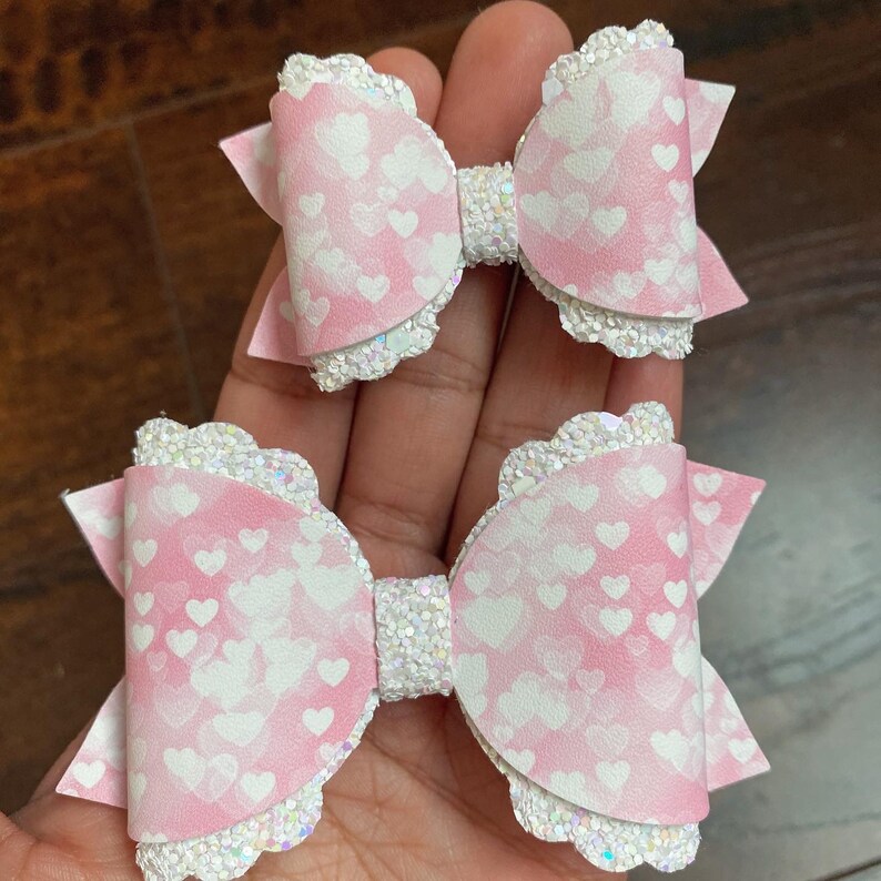 Adorable pink and white watercolour heart faux leather and chunky glitter bows pink and white heart Valentine\u2019s pigtail bows or headbands.