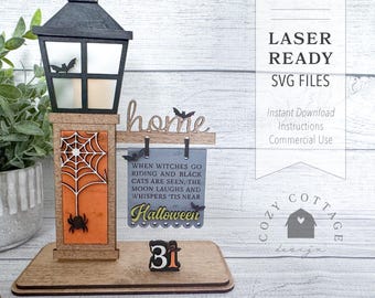 May include: A wooden Halloween sign with a black and white illustration of a cat riding a broom. The sign says "When witches go riding and black cats are seen, the moon laughs and whispers 'tis near Halloween". The sign is attached to a wooden lamppost with a black lantern on top. The lamppost is on a wooden base with the number 31 on it.