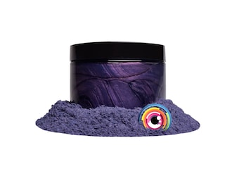 May include: A jar of purple iridescent mica powder with a black lid. The powder is in a small pile in front of the jar.
