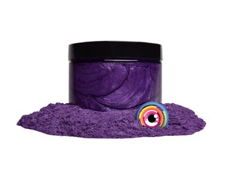 May include: A jar of purple mica powder with a black lid. The powder is spread out on a white surface.